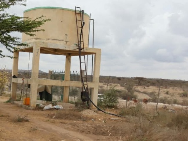 Raised concrete water tank with a metal ladder at a rural water point